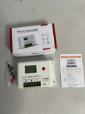 Shock Box Solar charge controller with packaging, manual, and accessories on a gray surface